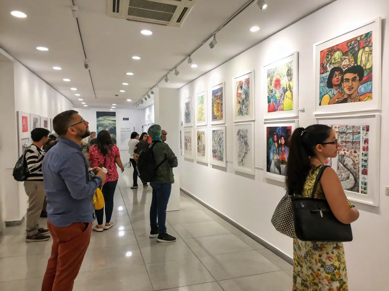An image of a SILVA-organized photography exhibition, showcasing impactful environmental photography. The setting is a gallery with visitors admiring the artwork.